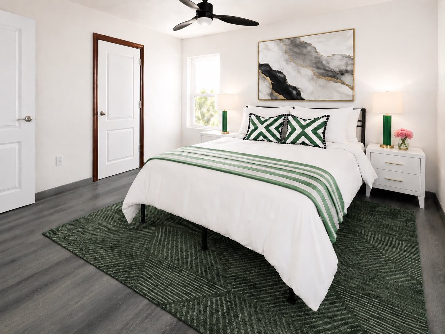 Plan 2 furnished bedroom with green accents, area rug, and two nightstands